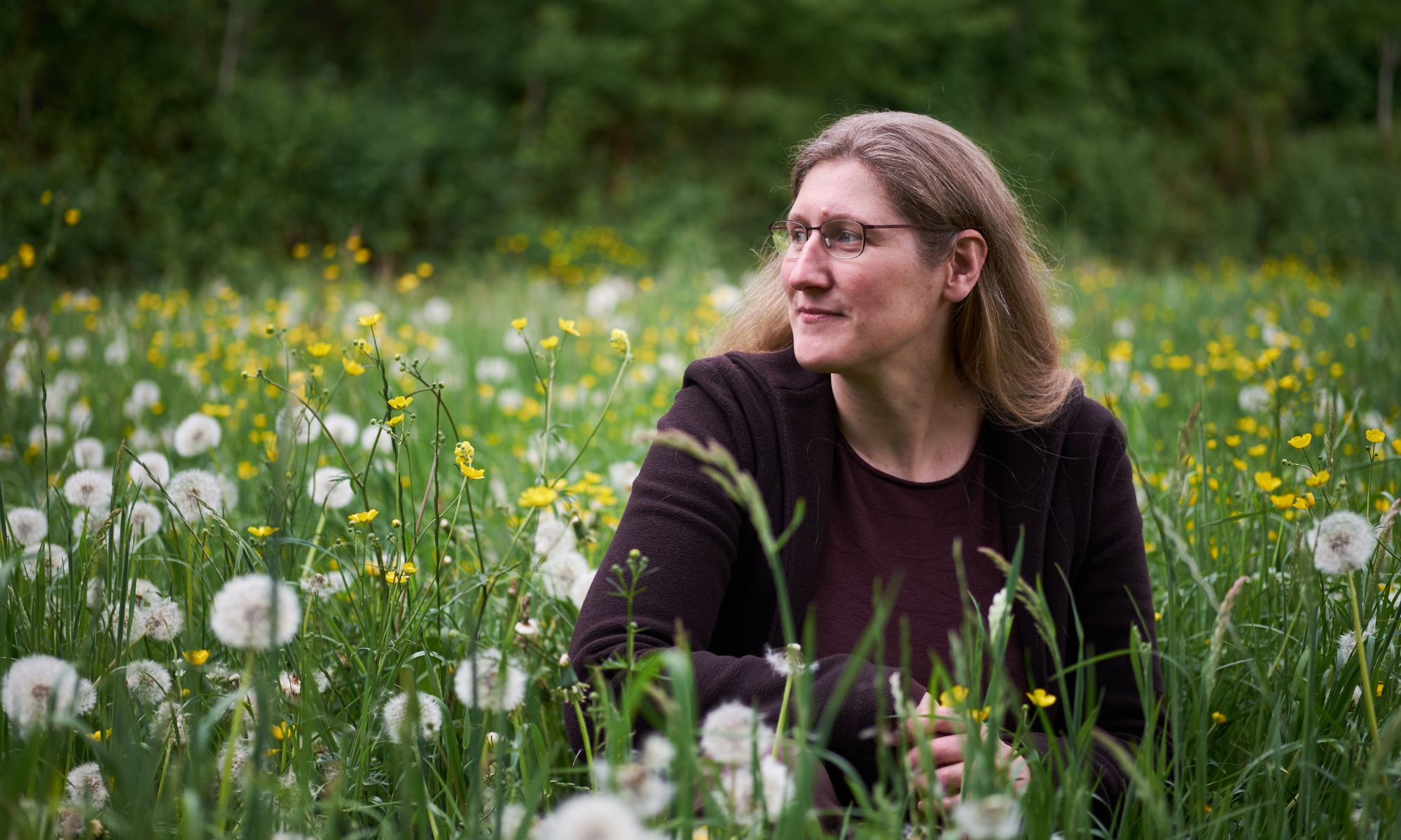 Dorothee sitzt auf einer Wiese; Foto: Maik Salzmann